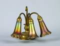 A Tiffany Bronze and Favrile Glass Three Light Lily Lamp