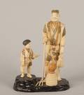 A Japanese Carved Ivory Figural Group of a Fisherman and Cormorant