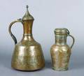 A Group of Two Silvered Copper Middle Eastern Ewers