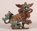 A Chinese Aubergine and Turquoise Glazed Ceramic Buddhist Lion