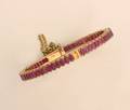A Ladys Yellow Gold and Ruby Hinged Bangle Bracelet
