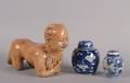 A Chinese Earthenware Figure of a Crouching Child