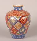 A Japanese ImariStyle Porcelain Brocade Enamel Vase