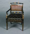 A Regency Style Black Lacquer and Gilt Armchair