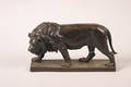 A Bronze Figure of a Striding Lion