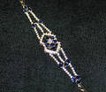 A Ladys 18 Karat Yellow Gold Diamond and Blue Sapphire Bracelet