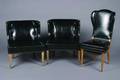 A Pair of Black Vinyl Upholstered Chairs