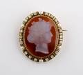 A Victorian Yellow Gold Pearl Diamond Black Enamel and White Carnelian Cameo Brooch