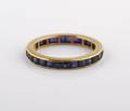 A 14 Karat Yellow Gold and Blue Sapphire Eternity Band
