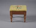 A Needlepoint Upholstered Footstool