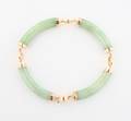 A Yellow Gold and Pale Green Jadeite Bracelet