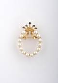 A 14 Karat Yellow Gold Pearl and Sapphire Brooch