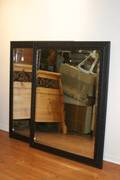A Pair of Contemporary Ebonized Wall Mirrors