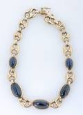 A Yellow Gold and Blue Sapphire Cabochon Bracelet