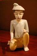 An Asian Carved and Painted Wood Figure of a Kneeling Man