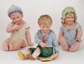 358 GROUP OF THREE PAINTED BISQUE PIANO BABIES