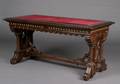 An American Renaissance Revival Brass Mounted Walnut Library Table