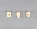 A Group of Three Japanese Polychrome Painted Netsuke of Masks