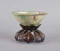 An Earthenware Bowl upon a Finely Carved Wood Stand