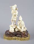 A Japanese Ivory Carving of Two Men and a Small Boy