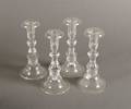A Set of Four Steuben Glass Candlesticks