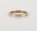 An 18 Karat Yellow Gold and Diamond Eternity Band