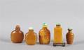 A Group of Chinese Carved Hardstone and Amber Snuff Bottles