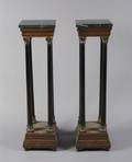 A Pair of Continental Neoclassical Style Ebonized and Parcel Gilt Pedestals