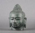 A Patinated Cast Metal Head Of Buddha