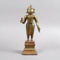 An Asian Gilt Metal and Lacquer Figure of a Standing Buddha