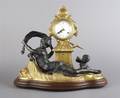 A German Gilt and Patinated Metal Figural Mantle Clock