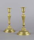 A Pair of Empire Style Brass Candlesticks