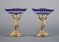 A Pair of Continental GiltMetal and Blue Cut to Clear Glass Figural Compotes