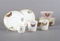 An Assembled Group of Butterfly Porcelain Cups and Saucers
