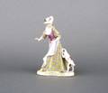 A Continental Porcelain Figure of a Woman and Dog