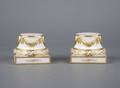 A Pair of Porcelain Parcel Gilt Stands
