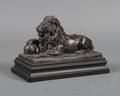 A Patinated Cast Metal Figure of a Recumbent Lion