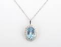 A 14 Karat White Gold Blue Topaz and Diamond Pendant