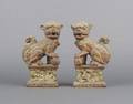 A Pair of Chinese Cast Iron Foo Dogs