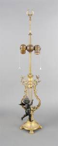 A Patinated and Gilt Bronze Figural Lamp
