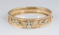 A 14 Karat Yellow Gold and Diamond Bangle Bracelet