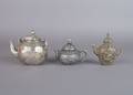 A Group of Three Chinese Metal Teapots with Covers