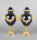 A Pair of Continental Gilt Metal Mounted Blue Porcelain Covered Urns
