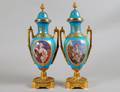 PAIR OF GILT BRONZE MOUNTED SEVRES PORCELAIN URNS AND