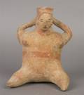 A Mexican Seated Pottery Figure