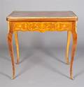 A Louis XVI Style Marquetry and Gilt Metal Mounted Games Table
