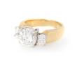 An 18 Karat Yellow and White Gold Three Stone Diamond Ring