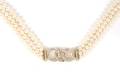A Three Strand Cultured Pearl Necklace with an 18 Karat Yellow Gold and Diamond Clasp