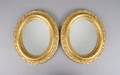 A Pair of Oval Giltwood Mirrors