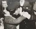 A Signed Photograph and Negative of Elvis Presley in Uniform Hugging Gary Pepper